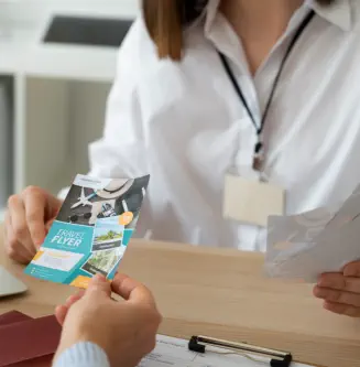 two person holding to a piece of paper