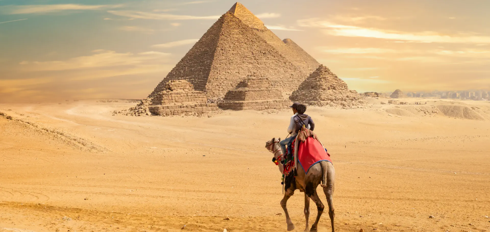 two person riding a horse near the pyramid of giza