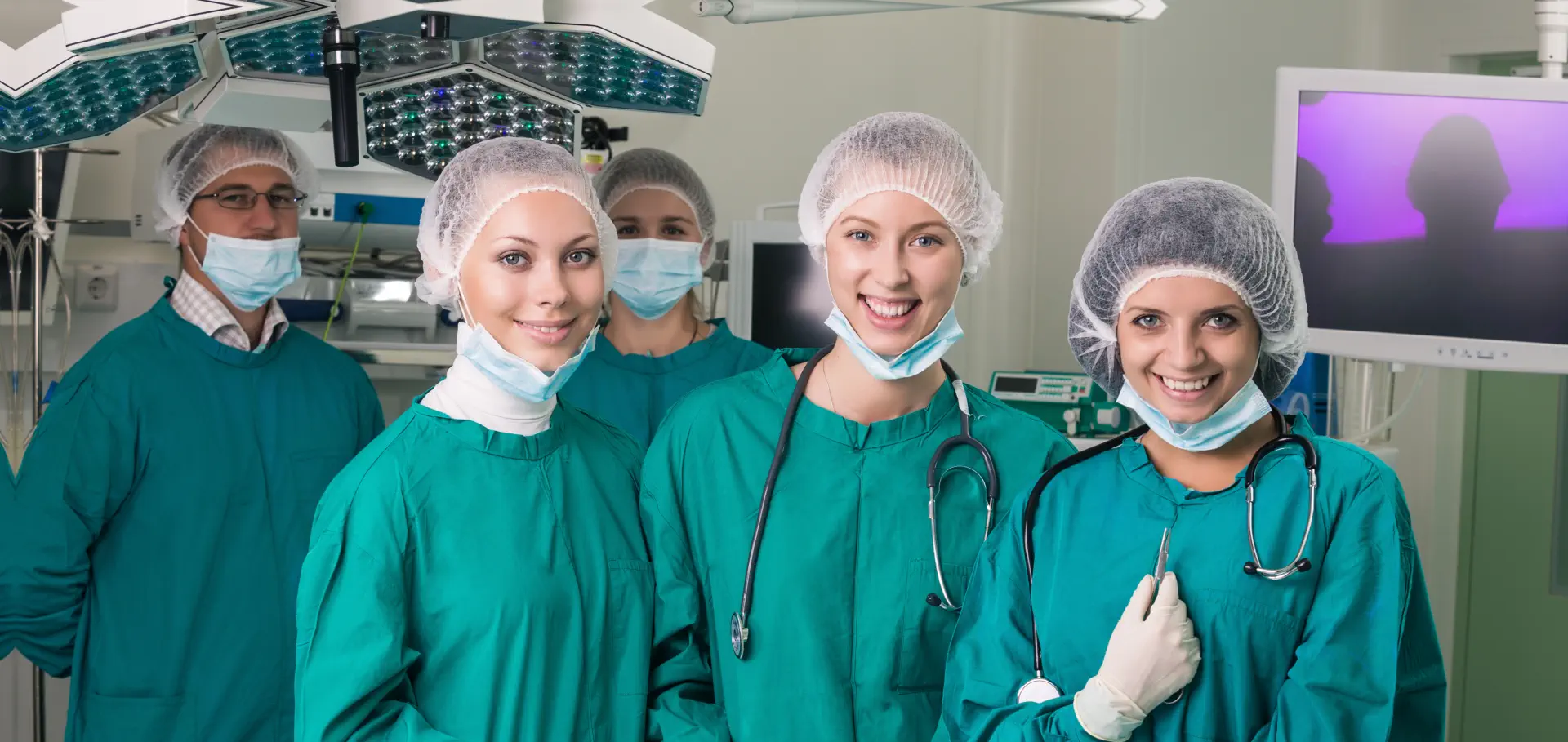 three healthcare professionals smiling together