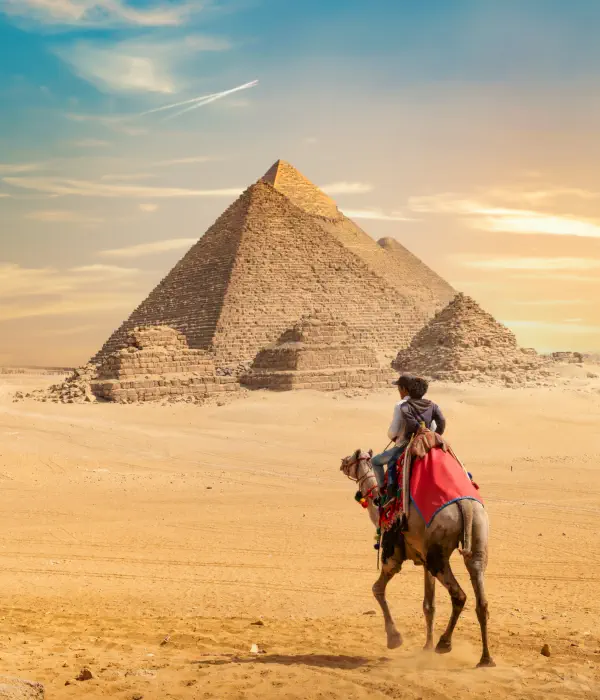 two person riding a horse near the pyramid of giza