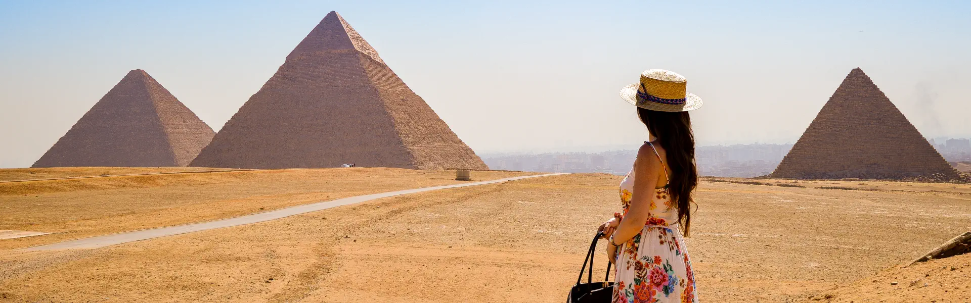 a woman standing  in front of a pyrammid