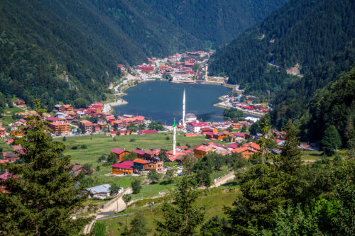 The mountain valley with a trout lake and a small village 