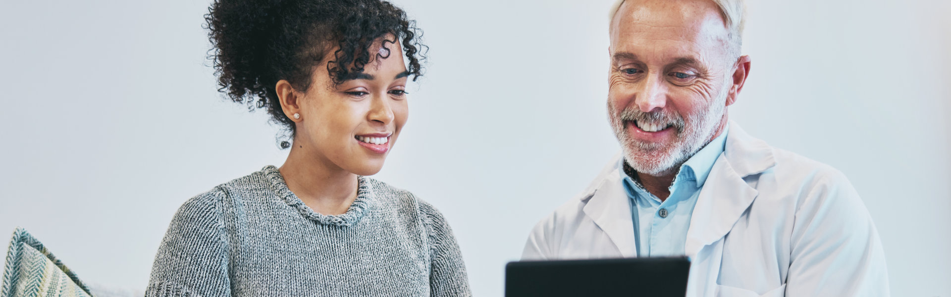 doctor showing results to his patient in Ipad