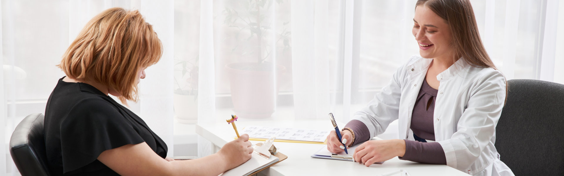 doctor and patient writing