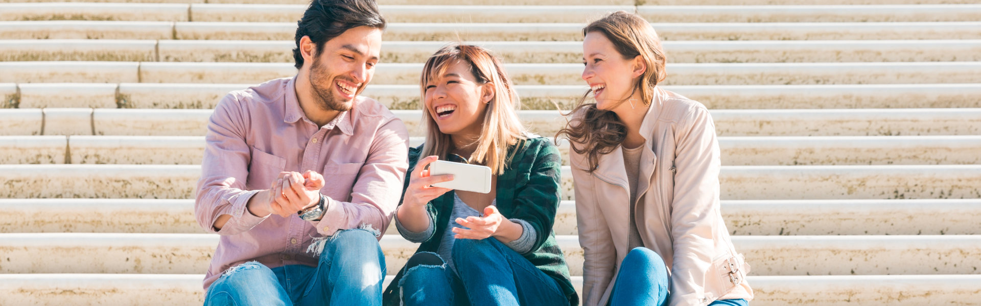 three person laughing together