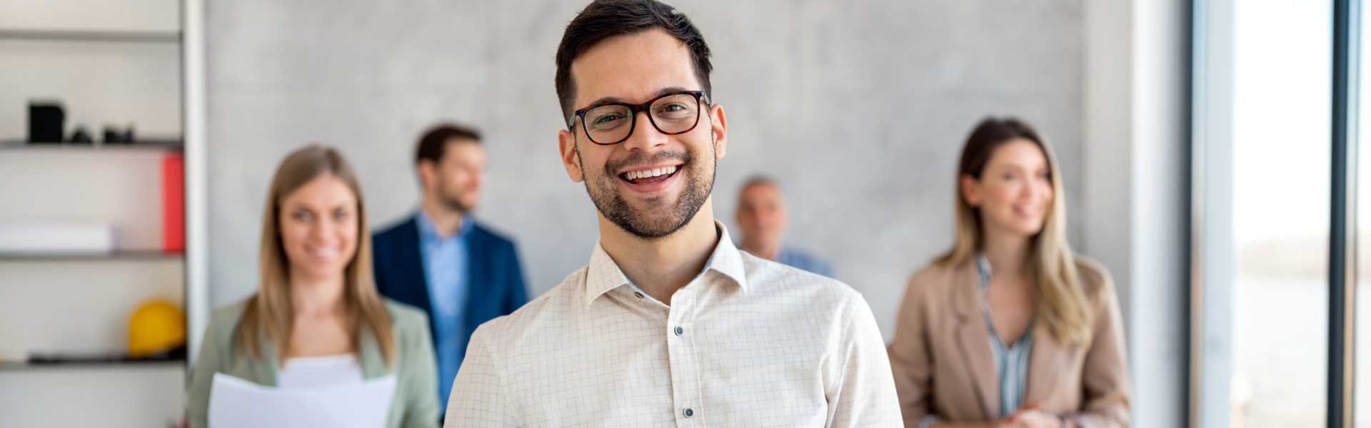 a man smiling in front of other people